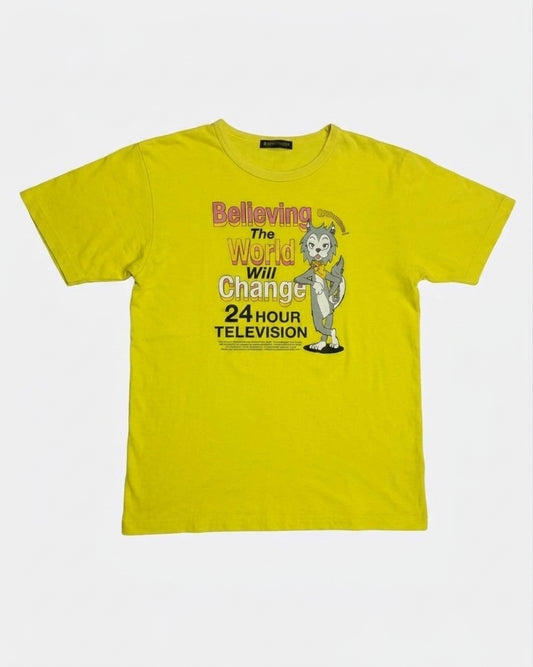 Alt Text: Yellow 24 Hour Television charity t-shirt featuring graphic text Believing The World Will Change and anime character, front view