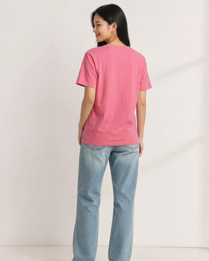 Woman wearing a pink short-sleeve crewneck t-shirt viewed from the back