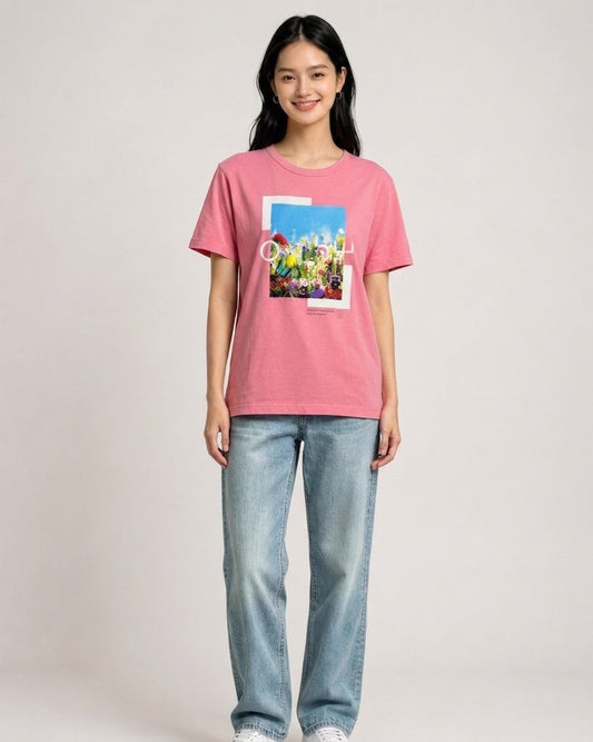 Woman wearing a pink 24Hour Television t-shirt featuring a colorful floral photo graphic print on the front