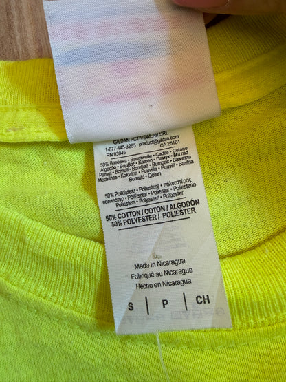 Close-up view of the white inner fabric care tag on a neon yellow Gildan t-shirt showing 50% cotton and 50% polyester material composition and Made in Nicaragua text