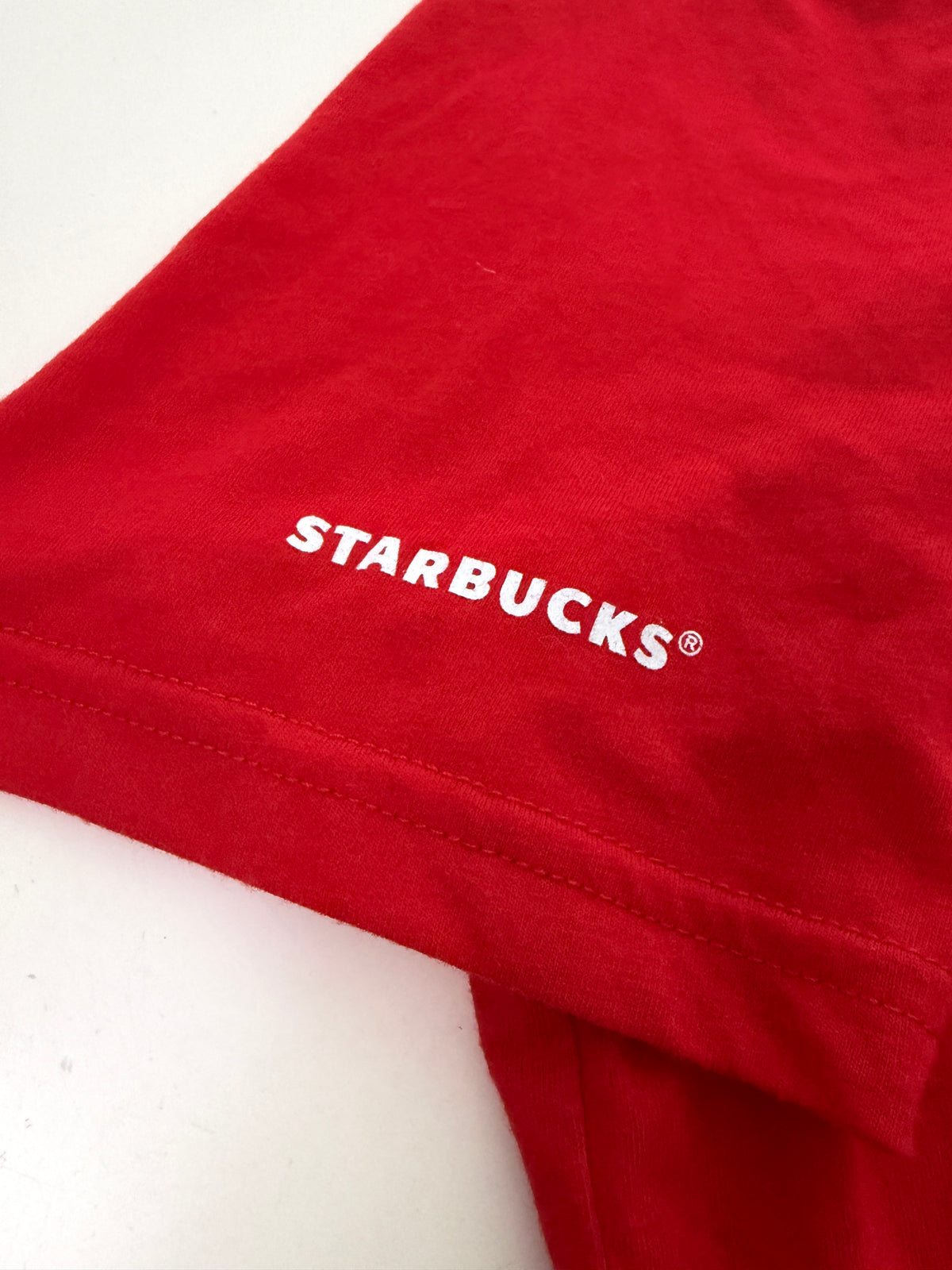Leox Hub Starbucks Japan 2024 holiday staff t-shirt in red cotton with white logo detail on the sleeveLeox Hub Starbucks Japan 2024 Holiday staff t-shirt