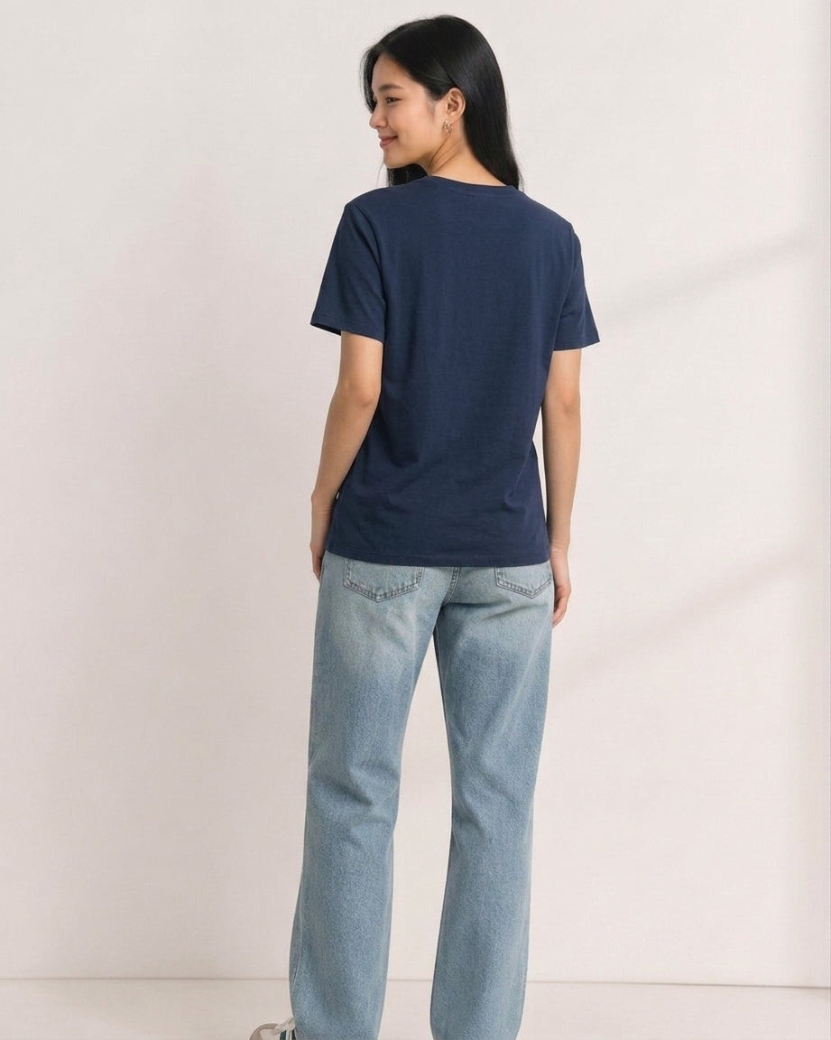 Woman wearing a plain navy blue Peanuts t-shirt seen from behind
