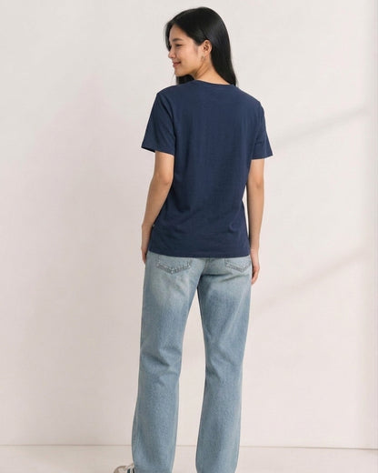 Woman wearing a plain navy blue Peanuts t-shirt seen from behind