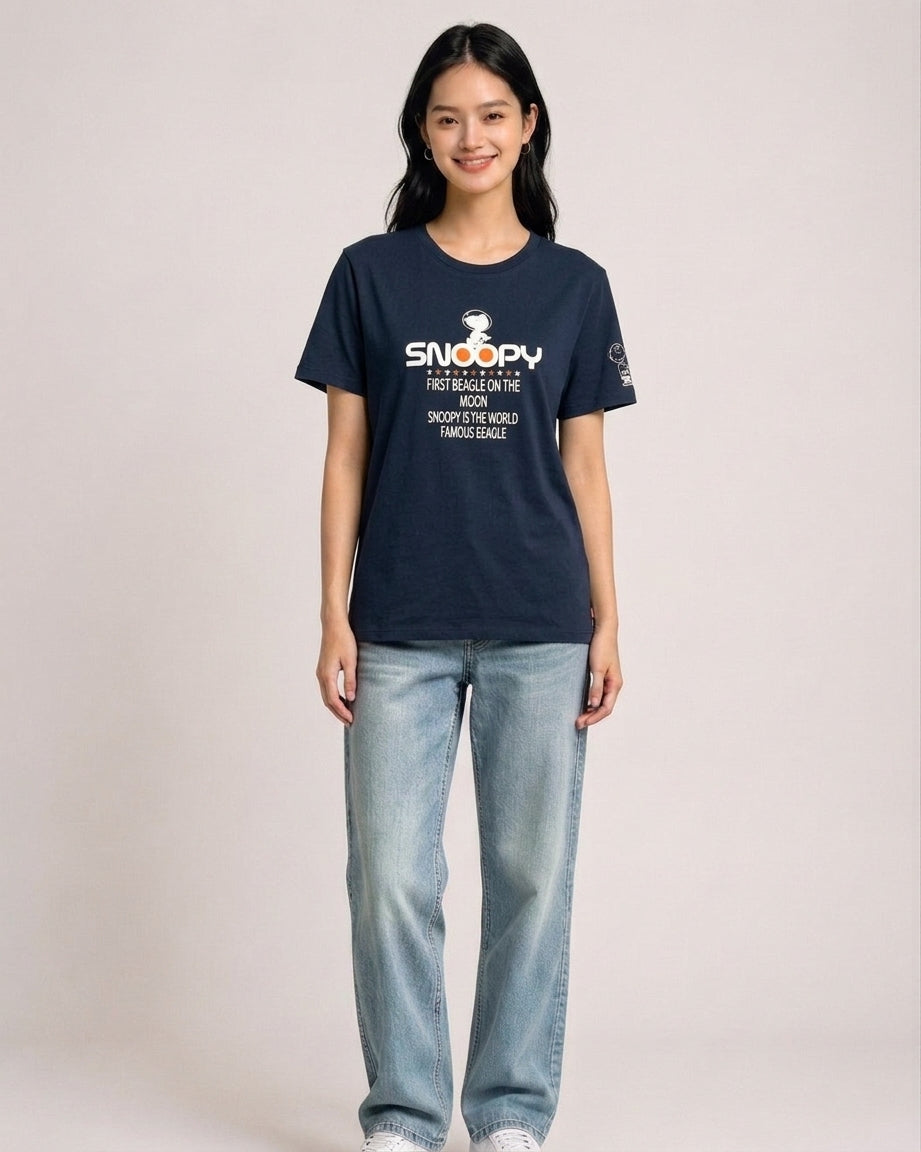 Woman wearing a navy blue Peanuts Snoopy First Beagle on the Moon graphic t-shirt