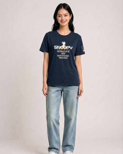 Woman wearing a navy blue Peanuts Snoopy First Beagle on the Moon graphic t-shirt